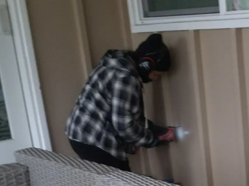 Professional electrician installing an exterior outlet in LaGrange